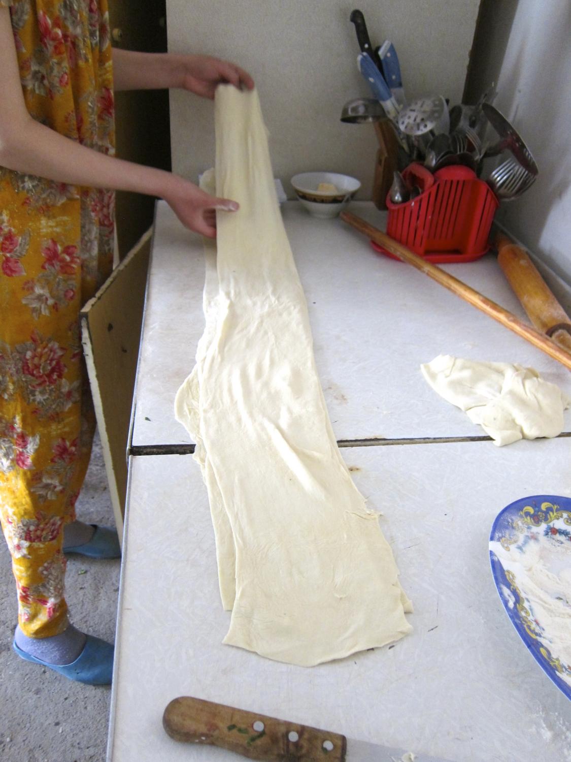 Stretch out the pastry before cutting it into squares
