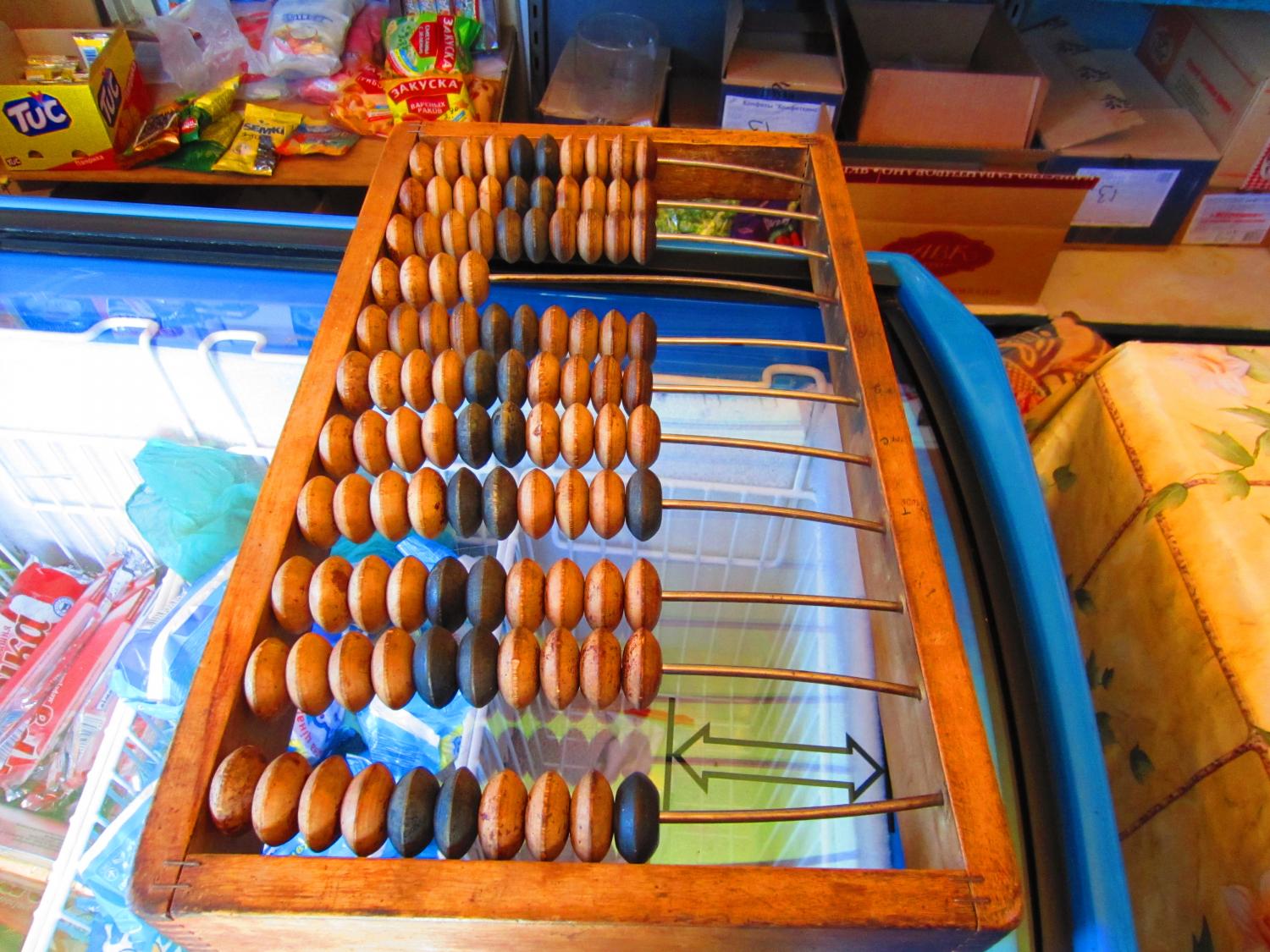 This shop owner still uses an abacus sometimes, even though she also has a calculator. When I asked why, she said that everyone used these before calculators and it's still faster for her sometimes.