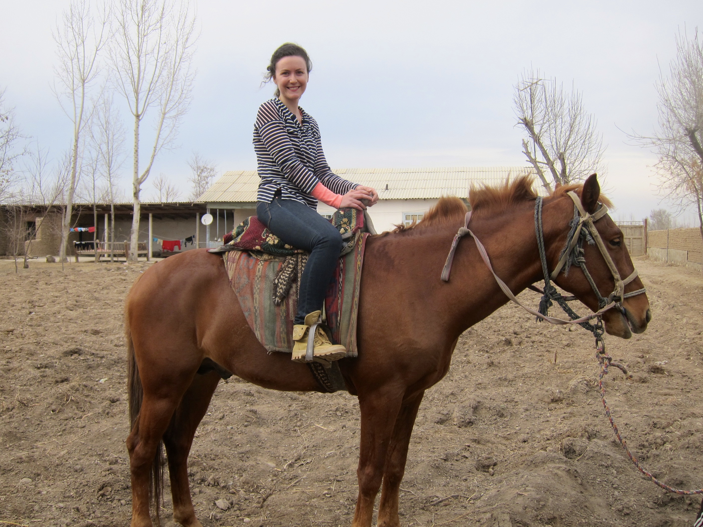 Riding Goldie the Buzkashi horse on a Kiva borrower visit.
