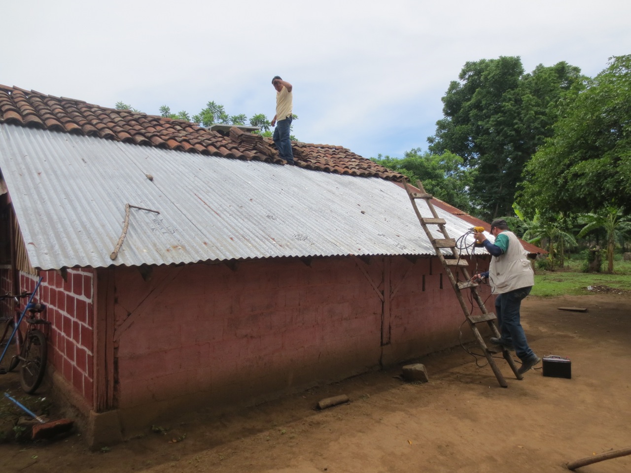 Finishing the installation (the solar panel is just to the left of the technician on the roof)