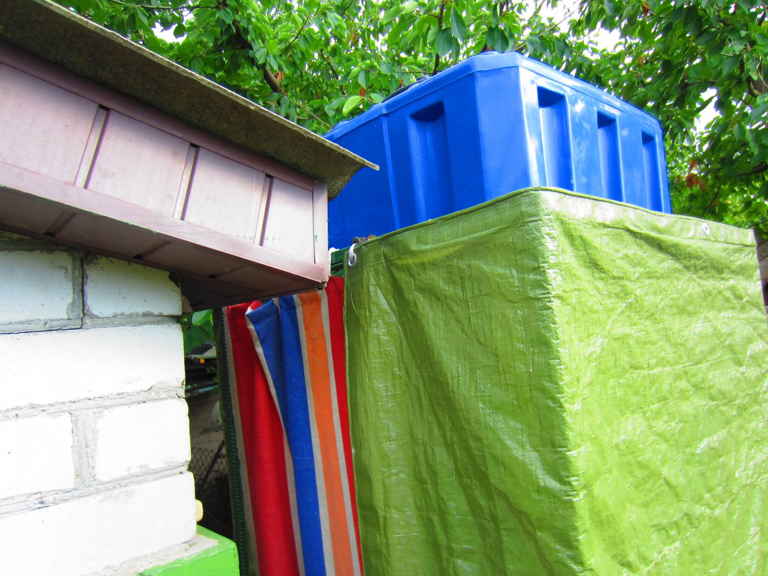 Shower on the right, next to the outhouse.