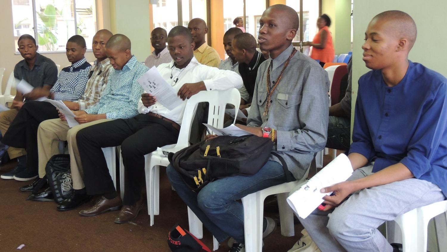 Students ask questions and review the Kiva brochure, which provides details about Kiva loans