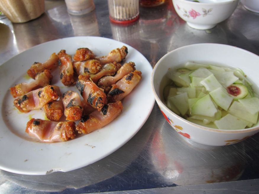 Cha Tom: grilled rolls filled with shrimp paste served with a sweetened fish sauce.