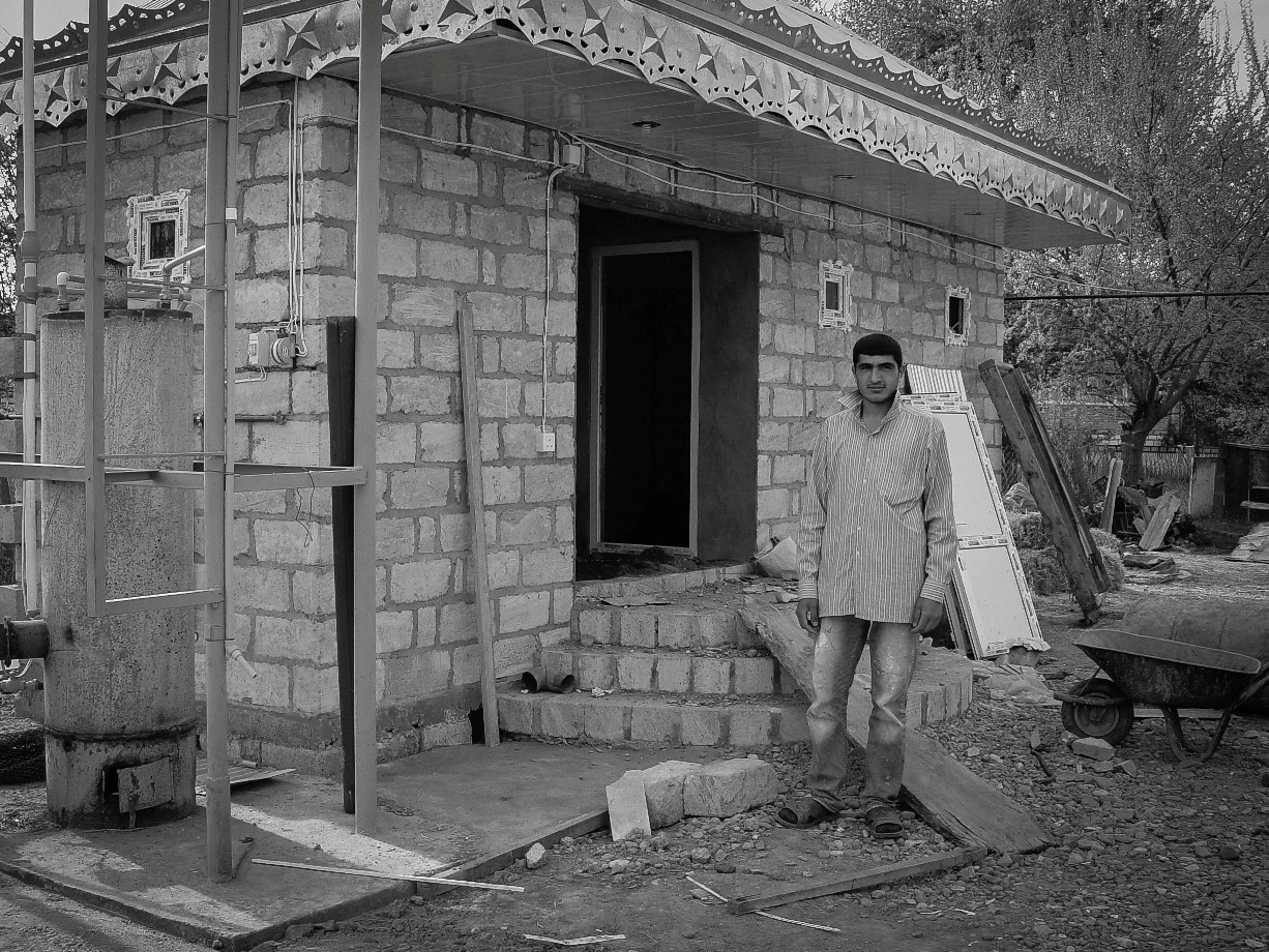 Elshad, a handyman, with his new banya under construction. He has to make his home presentable for his upcoming marriage.
