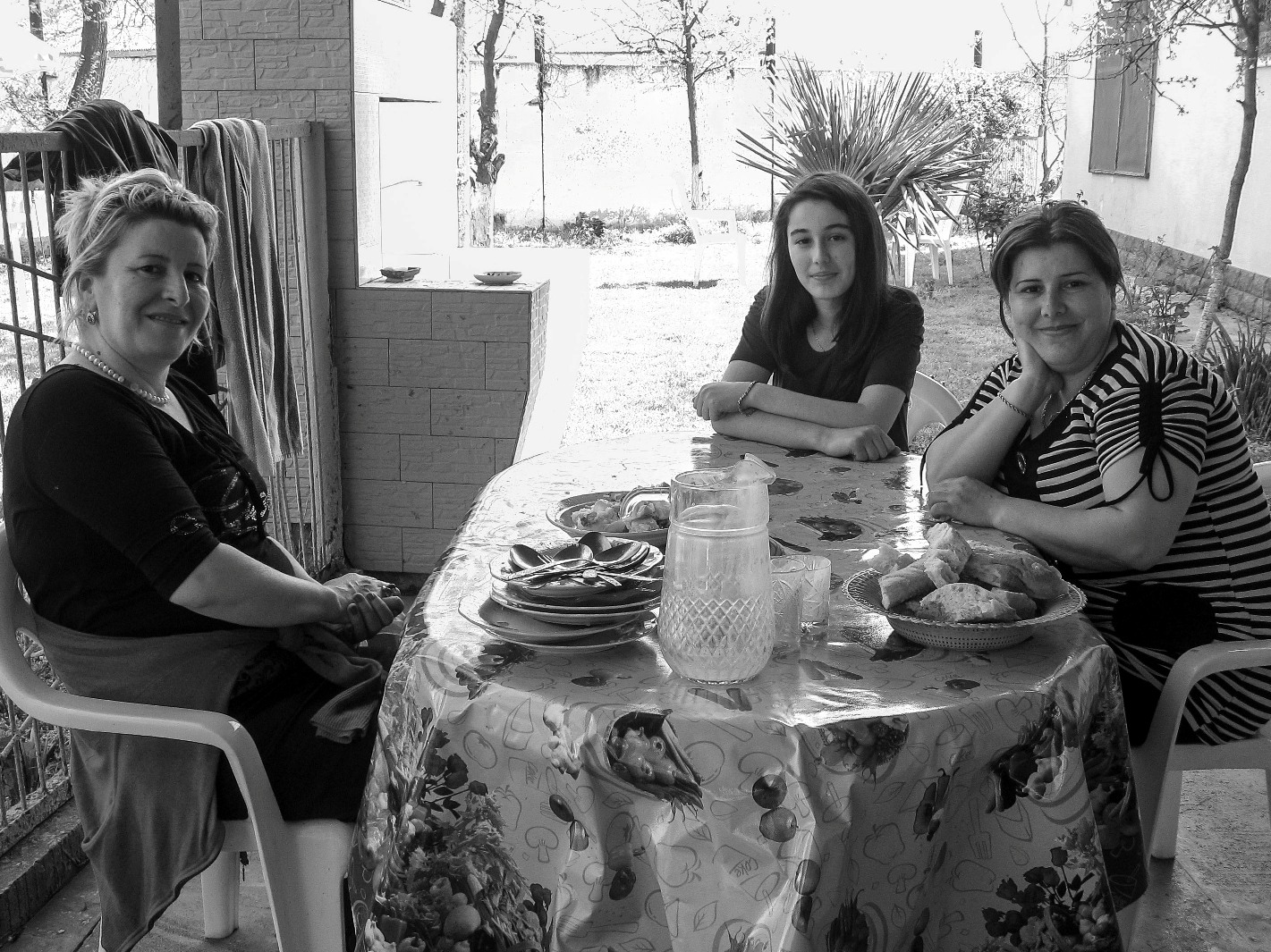 Relatives enjoy a lazy weekend in the shade at their home in Imishli.