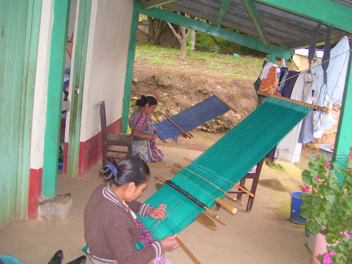 6 "Working in Community." Here, two microfinance borrowers from Friendship Bridge weave with a traditional back-strap loom. The first solidarity group formed within Friendship Bridge was composed of 20 surviving widows from the Quiche Region.