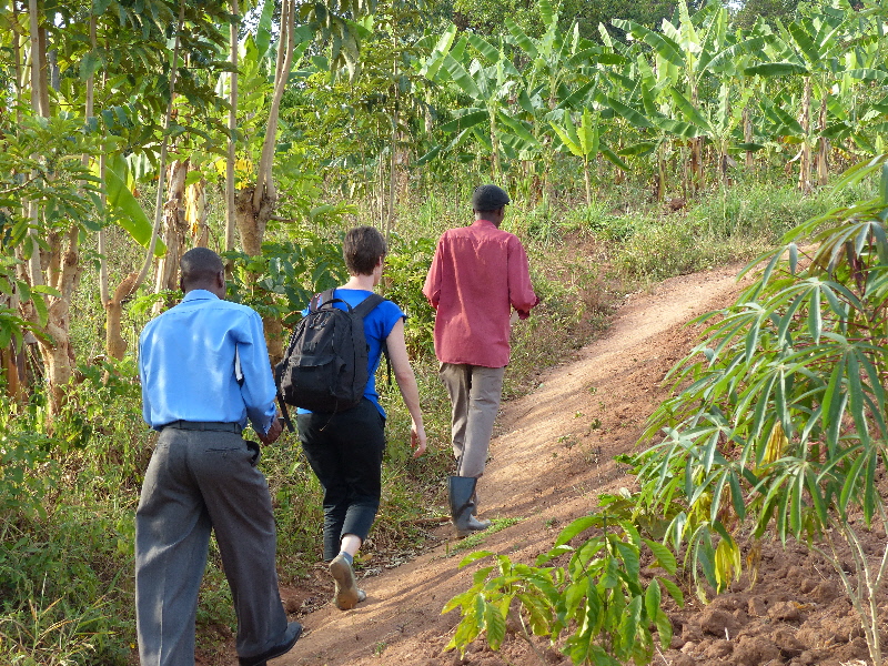 walking around Pascal's farm with Godfrey, a CKW trainer from Grameen Foundation