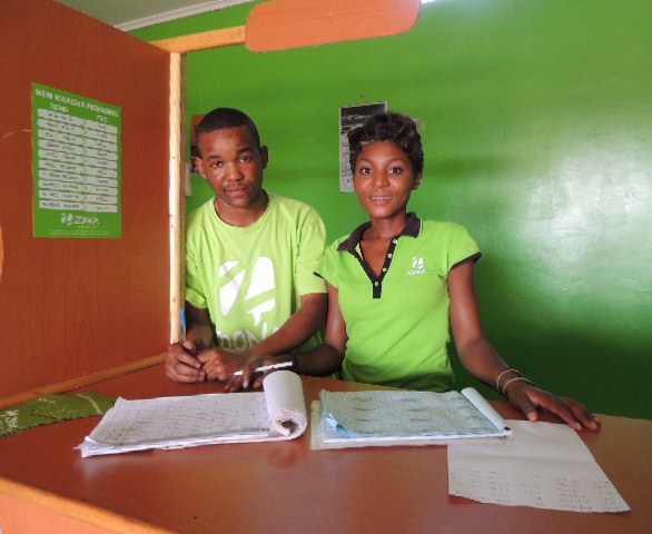Two tellers at her second shop