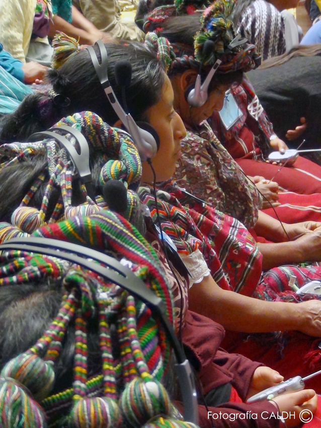 8 Female witnesses from the Ixil Trial of Quiche. Headphones were used throughout the trial of Rios Montt to accommodate some of the 23 different Mayan languages represented in Guatemala. (Permission to use this photo obtained from Jose Rodriguez of CAL CALDH. Photo credits: José Rodríguez CALDH (Center for Human Rights Legal Action)