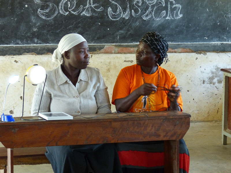 Kiva borrower Jane Francis (right) with another Solar Sister