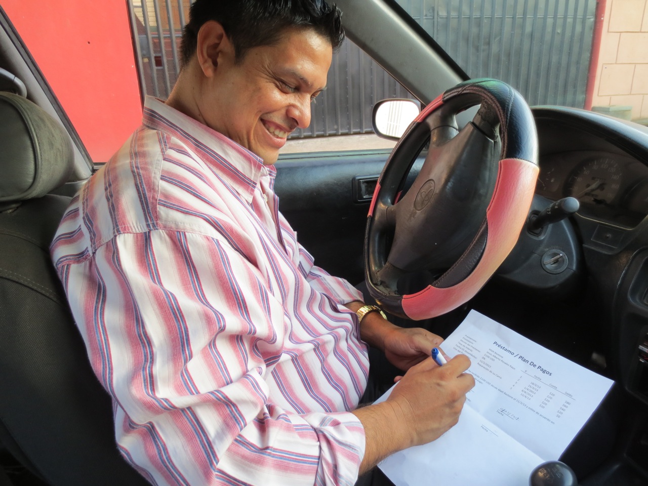 Jesús signing our loan agreement on disbursement day