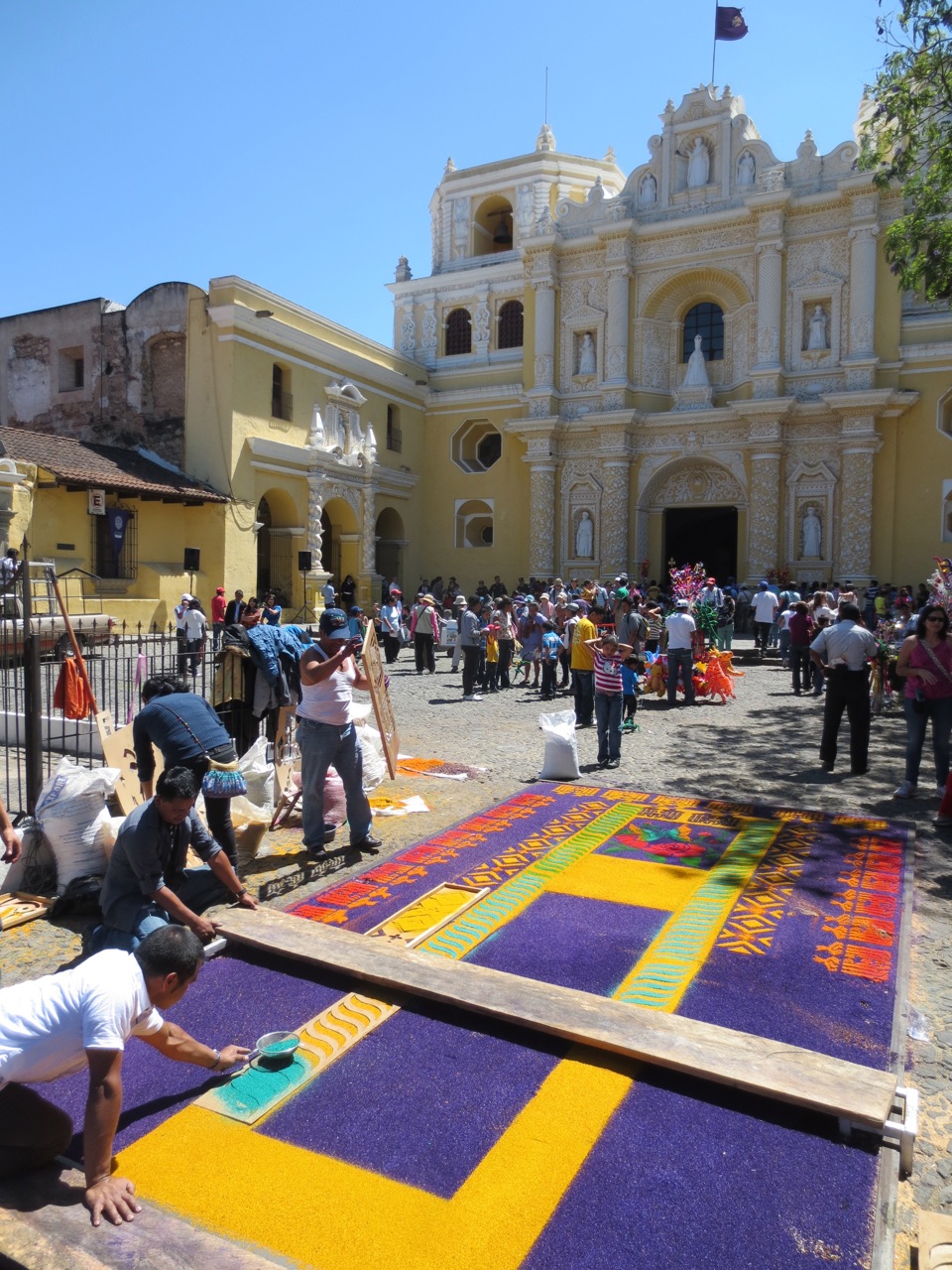 Sawdust alfombra being constructed outside a church named Nuestra Señora de la Merced (Our Lady of Mercy)