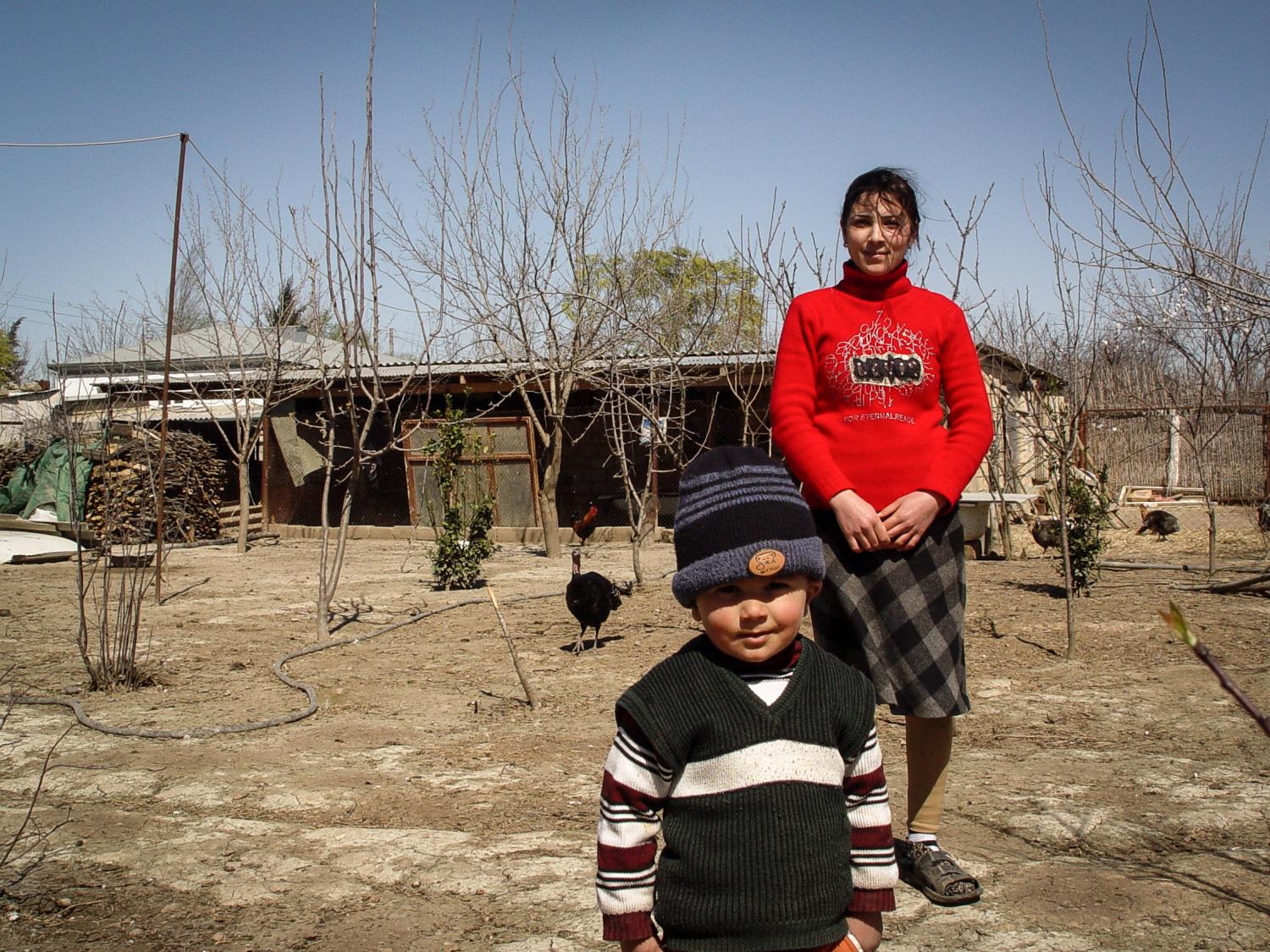 Immi, with her 3 year old son, at her home in Bilasuvar, Azerbaijan, a new internally displaced persons (IDP) settlement built in 2003. In their new home, Immi's family is rebuilding their lives thanks to your support. With the Kiva loan, she was able to buy seeds, fruit tress, and fertilizer. As with all the IDPs in new government settlements, she was provided a plot of land. The food she grows and delivers using her brother's car is the primary source of income for her family. Immi wants to expand her business and grow more produce. Dimitri Zakharov, Azerbaijan