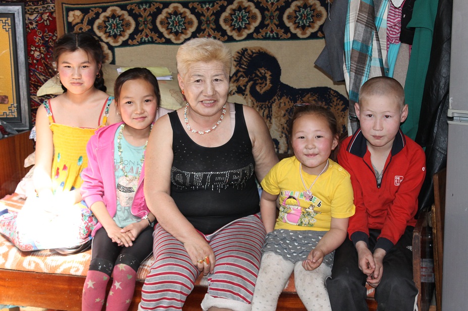 Meet XacBank borrower Zoya and four of her grandchildren in their ger in Ulaanbaatar. Widowed at 48, she started producing and selling organic dairy products in the countryside to help support her family. Her entrepreneurial spirit led her to start bartering for meat products, which she regularly brings to Ulaanbaatar to sell to clients in the city. There, she purchases clothing and other accessories and brings them back with her to sell in the countryside. Jane Imai, Mongolia.