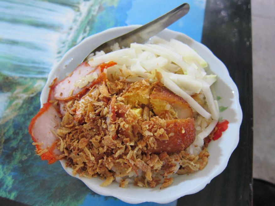 Xoi: sticky rice dish with barbecued pork, pickled cucumbers, a hard boiled egg, dried shallots, and drizzled with au jus. Love this for breakfast.
