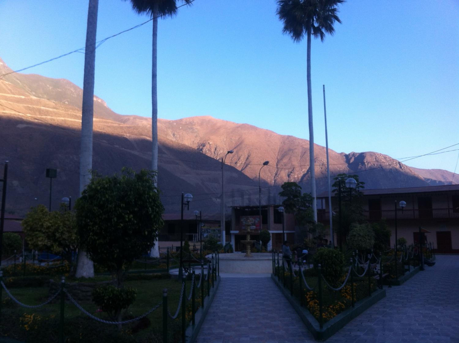 Callahuanca town plaza. Chrimoya fields on the hillside in the background.