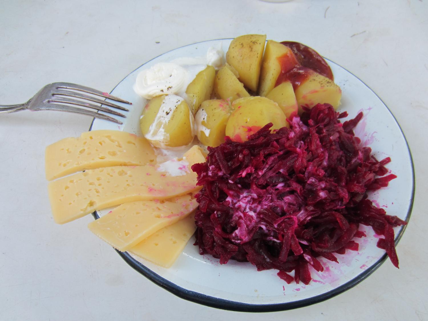 Grated beets with garlic and sour cream, potatoes with sour cream, and Russian cheese with tomato paste.