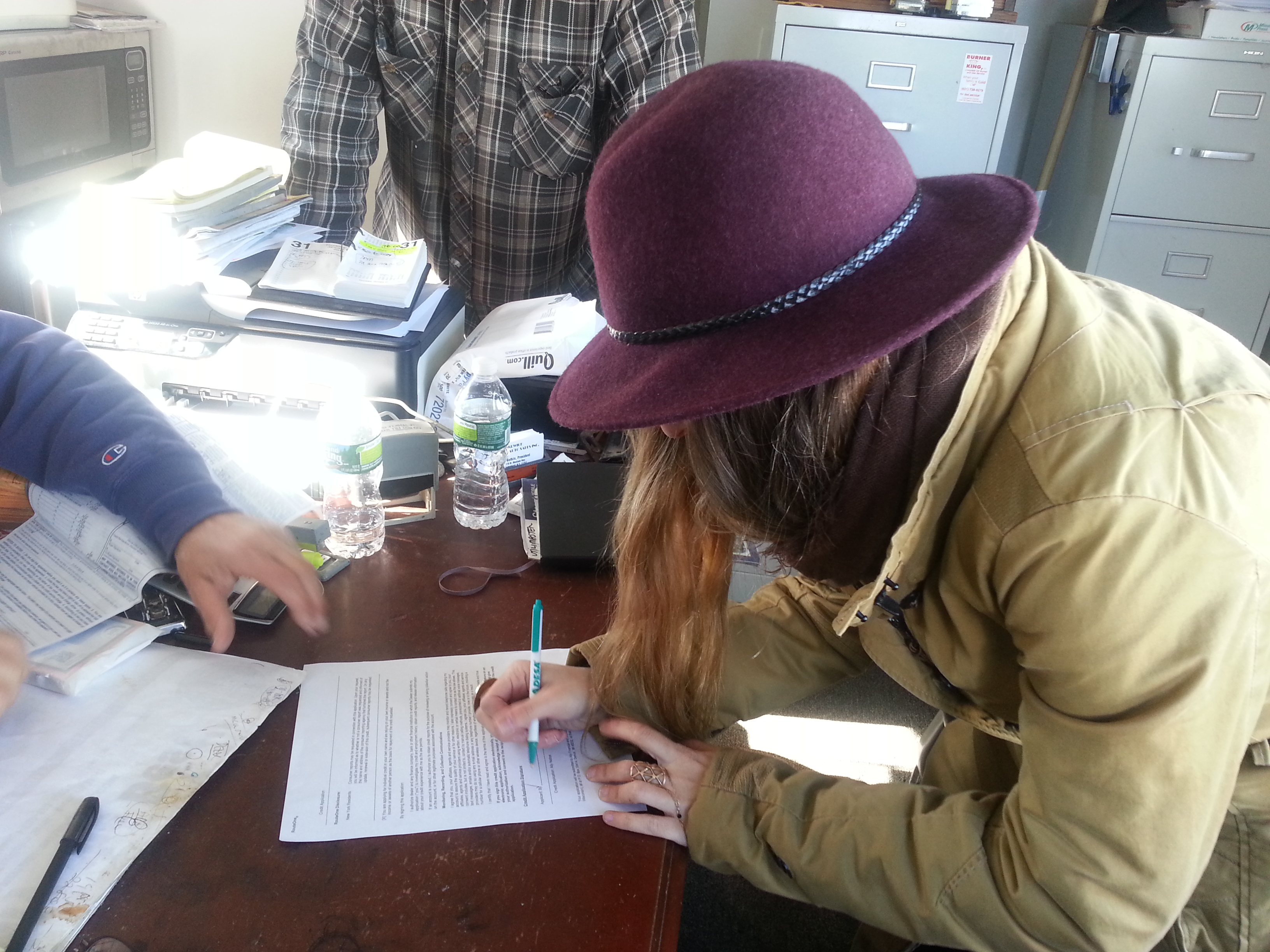 Jessie signing documents for her new truck - soon to become the wandering food truck of New York fashion