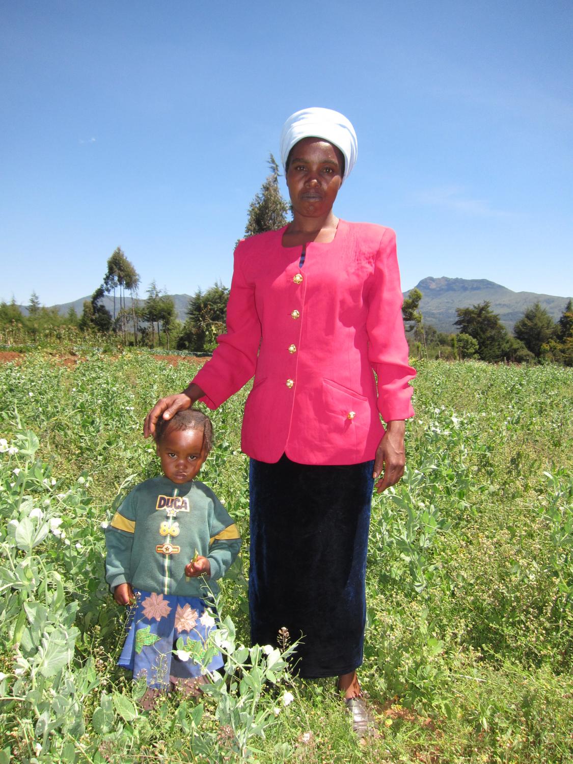 KADET borrower Keziah and one of her children in their plot of snow peas planted with a Kiva loan. Her wish is to open a small shop near her farm so she can supplement her farm income and provide school fees for her children. Jada Tullos Anderson, Kenya