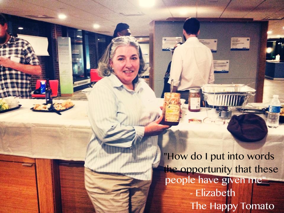 Elizabeth from The Happy Tomato, displaying her sauce at Community Investment Collaboratives graduation ceremony in Charlottesville, VA.