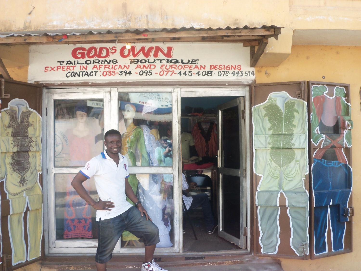 Tejan, proudly outside his new shop