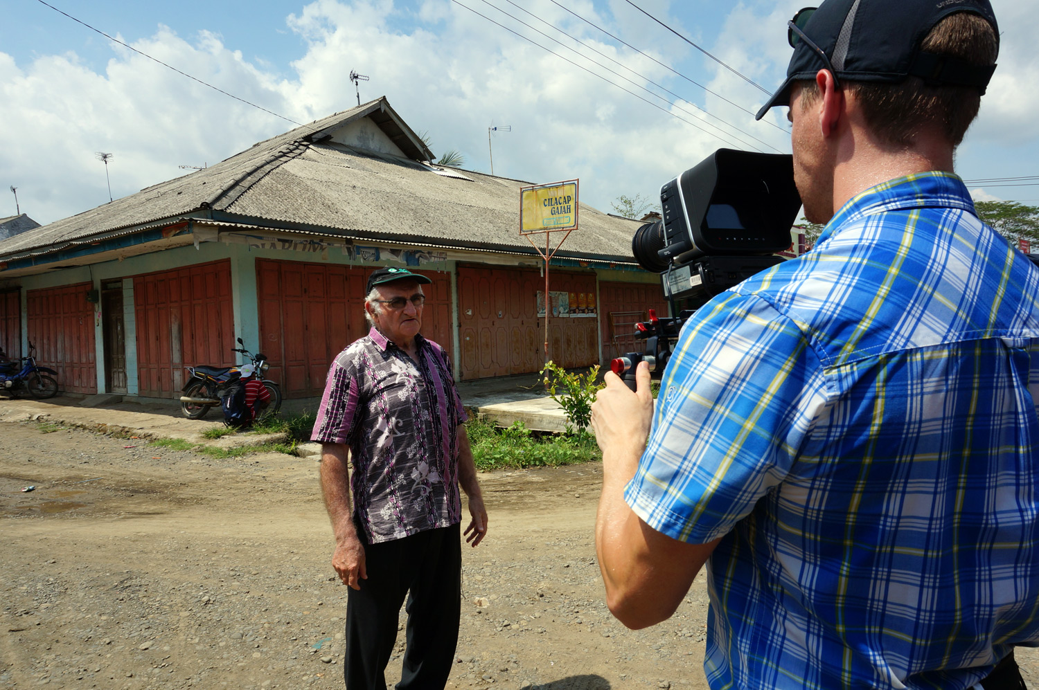 More interviewing Father Charlie. Photo credit: Yungkit