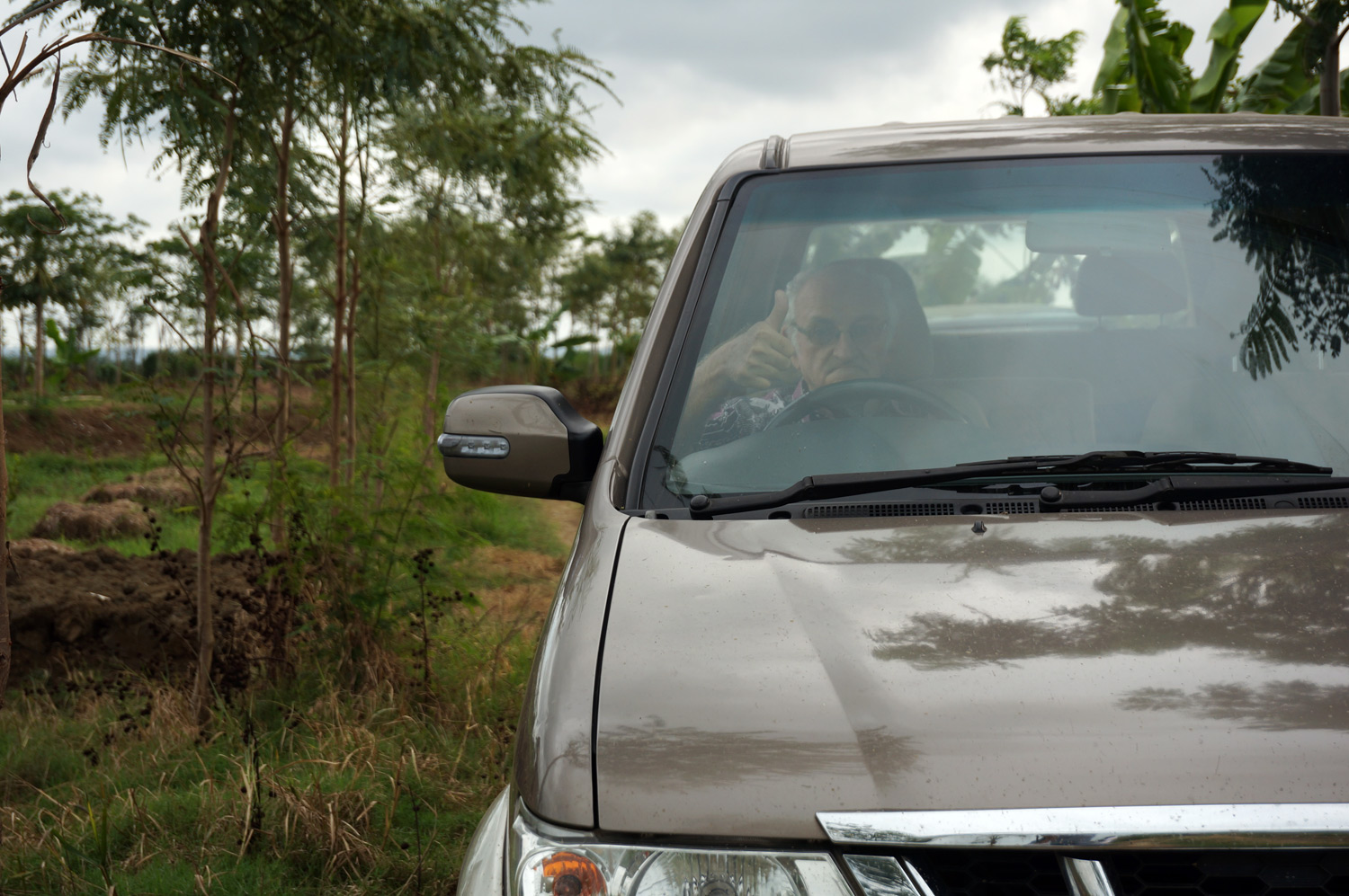 Filming Father Charlie in his car - bumpy ride when there are no roads! Photo credit: Yungkit