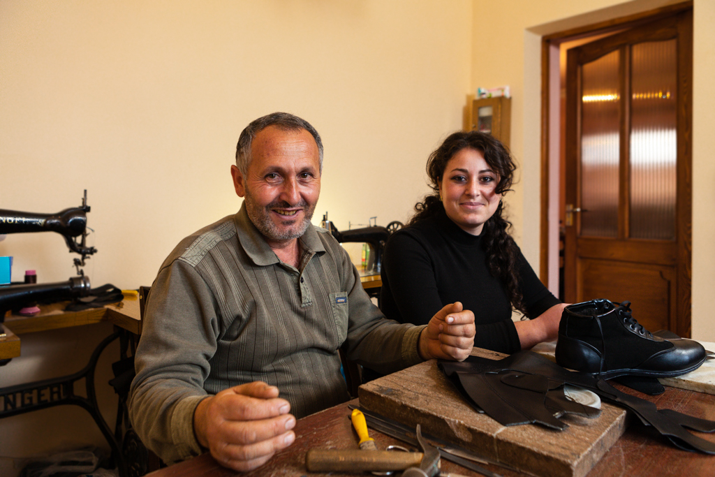 Stepan and his daughter at their work table (photo by Liz Fish)