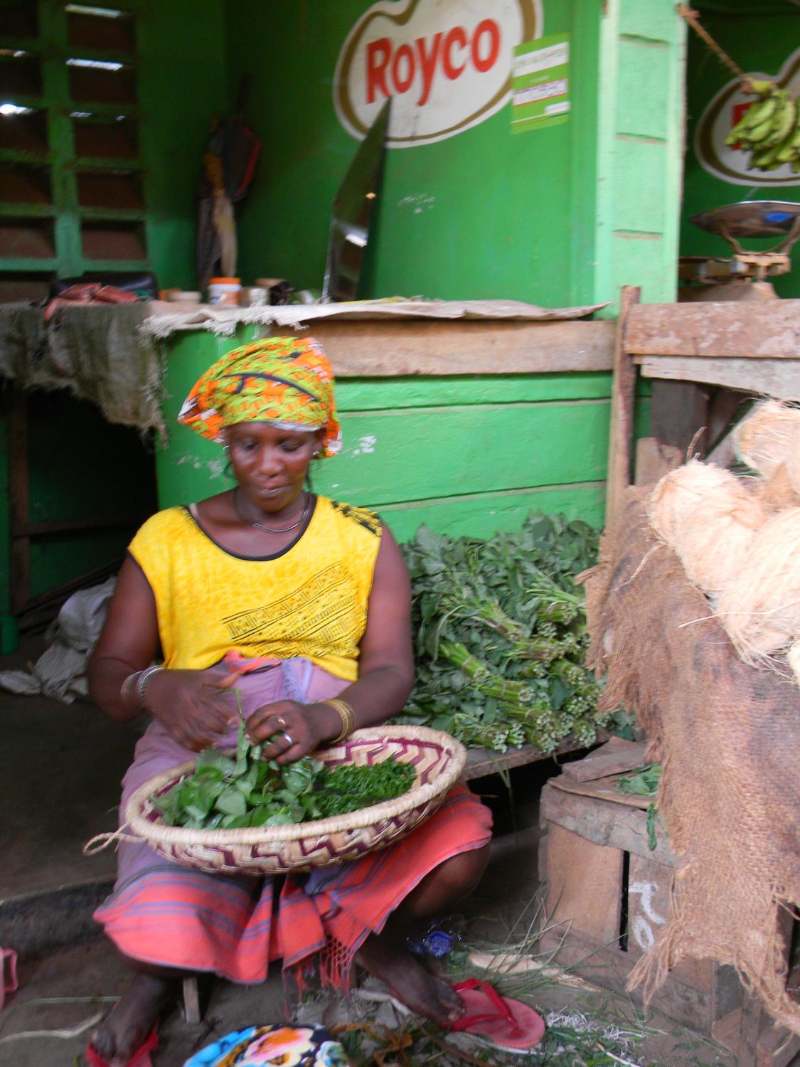 Sidi cutting the "mchicha" I bought from her. Its a bitter leafy vegetable that is sauteed with onions.