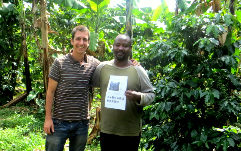 John Bosco and I in his farm as he proudly holds up his Kiva Profile