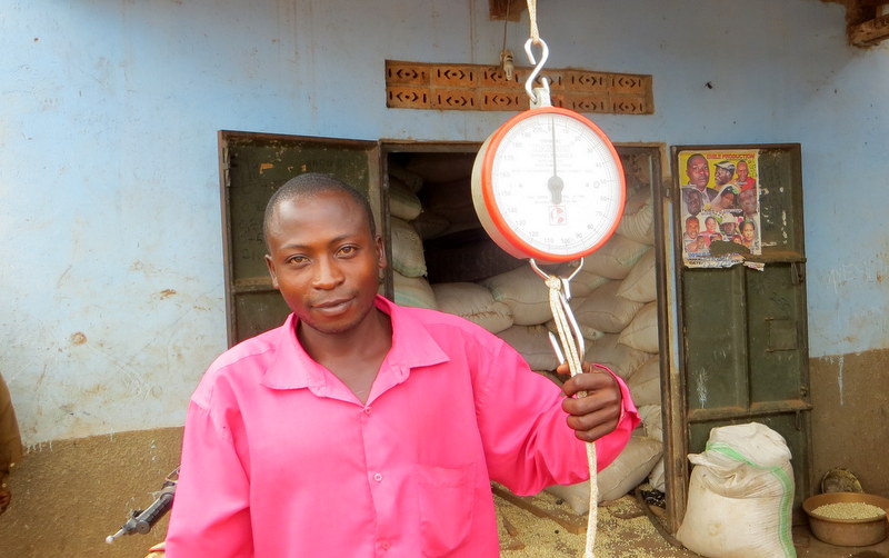 Vian with his scale in front of his maize storage space.