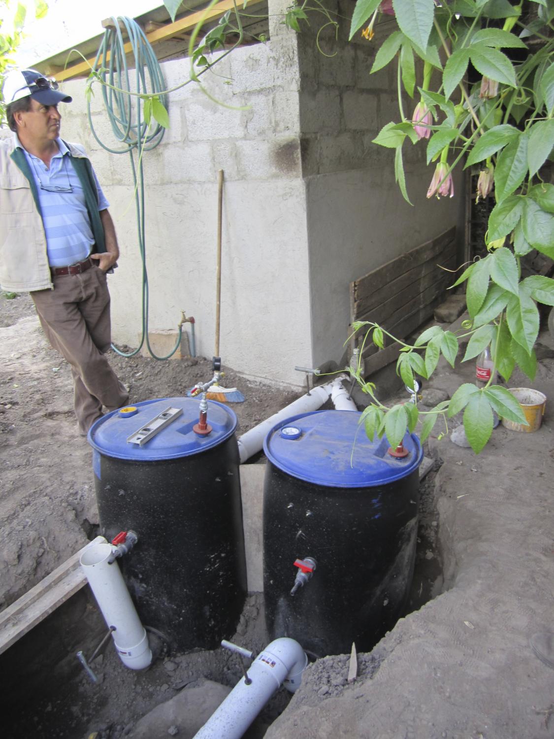 Implemented Biodigesters attached by pipes to the back of the pigpen. The top valve is to capture gas for cooking, the middle one is gas for fumigating crops, and the bottom pipe is to collect natural fertilizer.