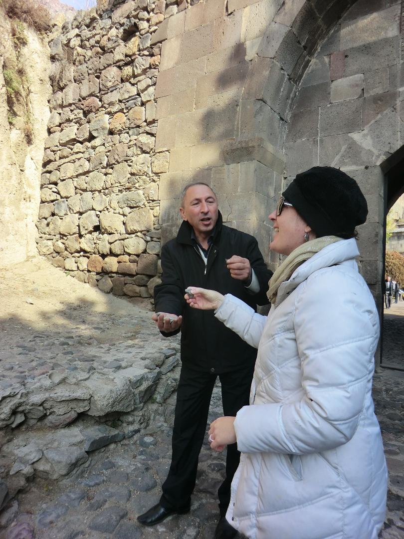 Shana throwing pebbles for a wish with Gagik advising