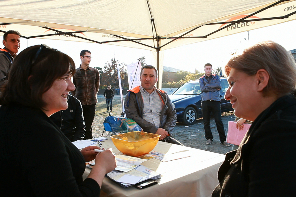 Nino, the Village Counsel, meets with potential borrower Lia