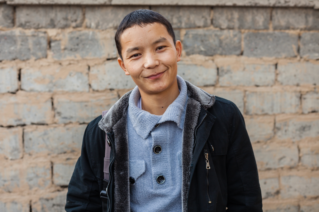 Almaz, AUCA student and entrepreneur, at his house where he's building new guesthouses