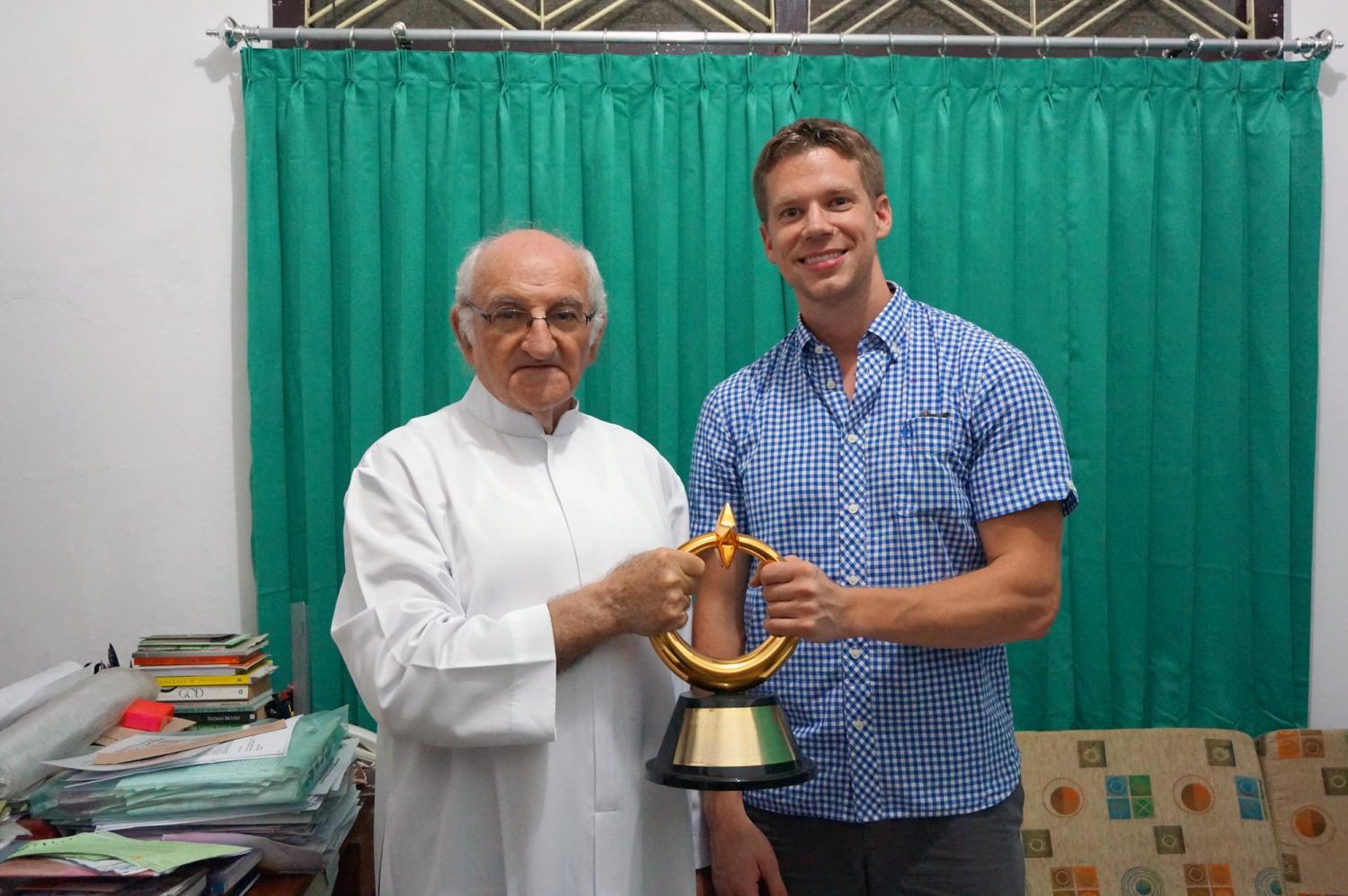 Father Charlie and I - holding his award for humanitarian efforts from the Muslim community