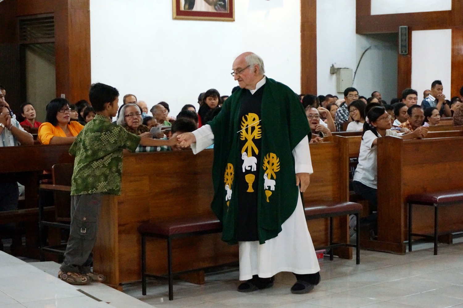 Father Charlie at Church service. Photo credit: Yungkit