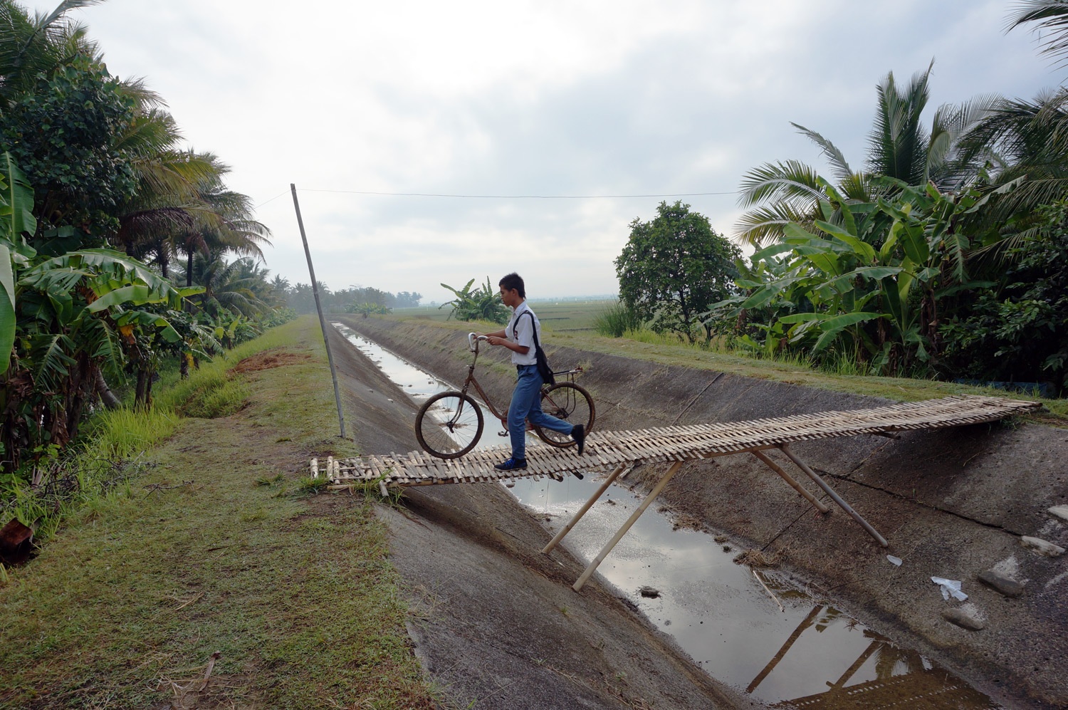Paulos with his bike headed to school. Photo credit: Yungkit