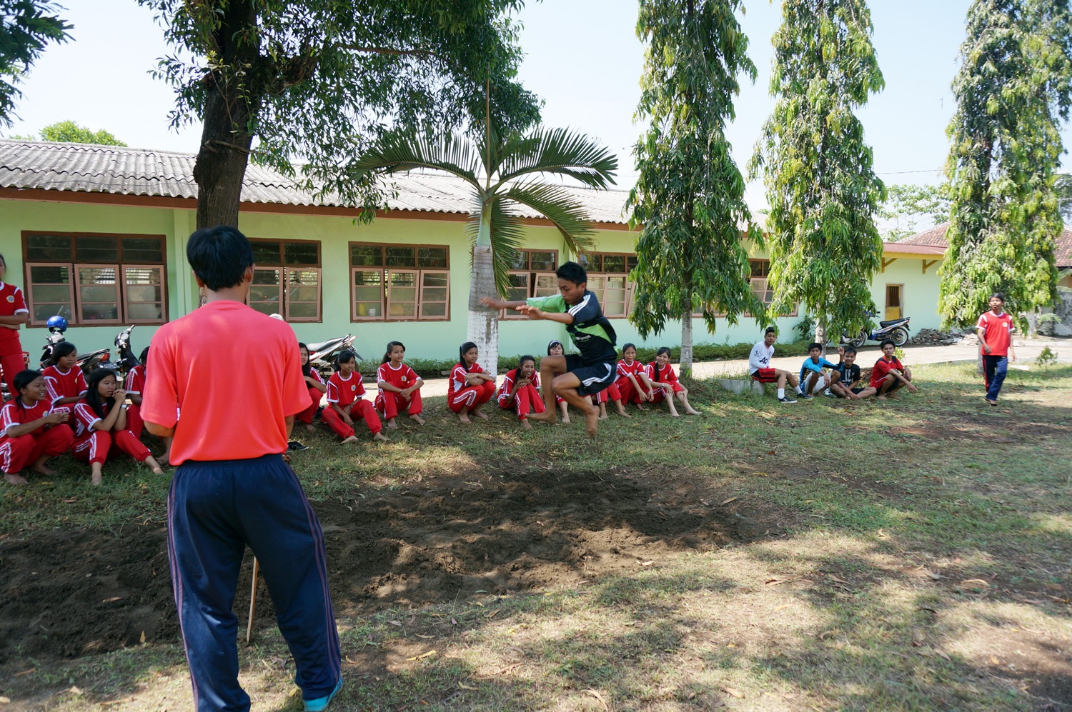 Students practicing for long jump. Photo credit: Yungkit