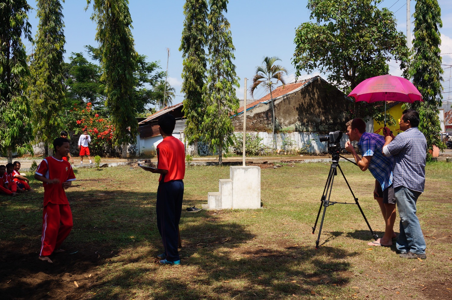 Good ol' pink umbrella. Filming the kids in action. Photo credit: Yungkit