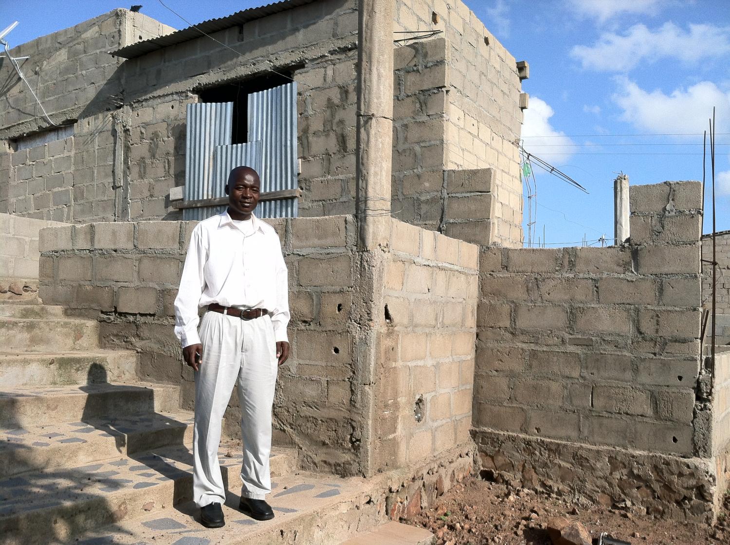 Carlos, a single father to a chronically ill child, is building a house with his Kiva loan so he can start a small store in his home.