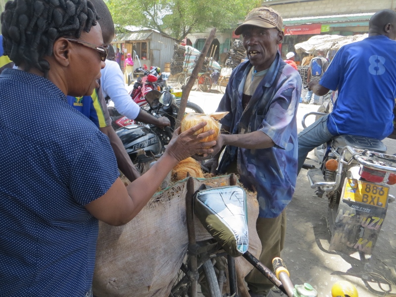 Buying a coconut for a drink and a snack