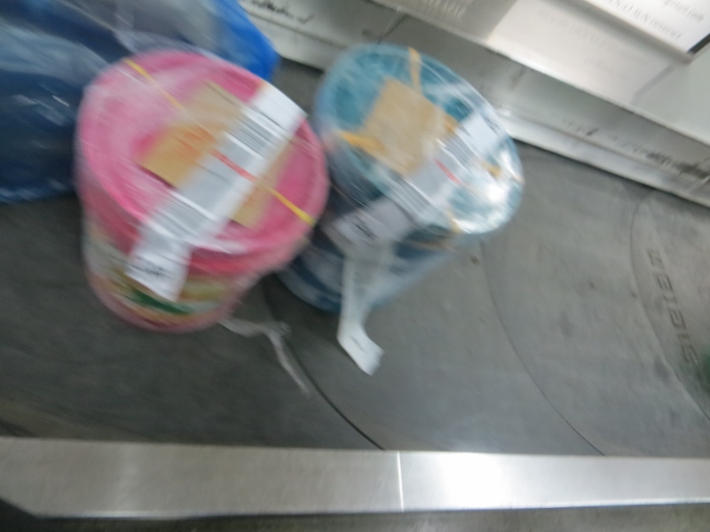 buckets of fish on baggage carosel