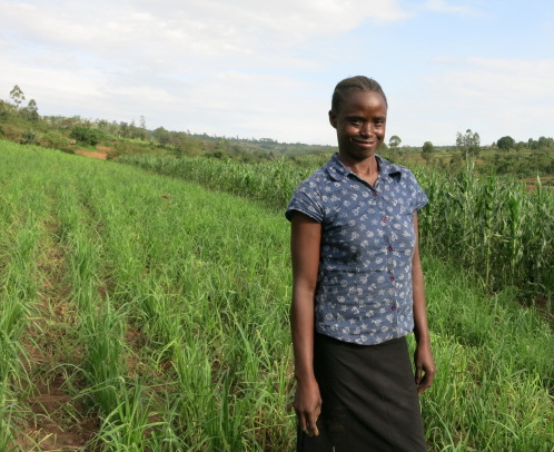 Janet in her field of maize, millet, and sorghum