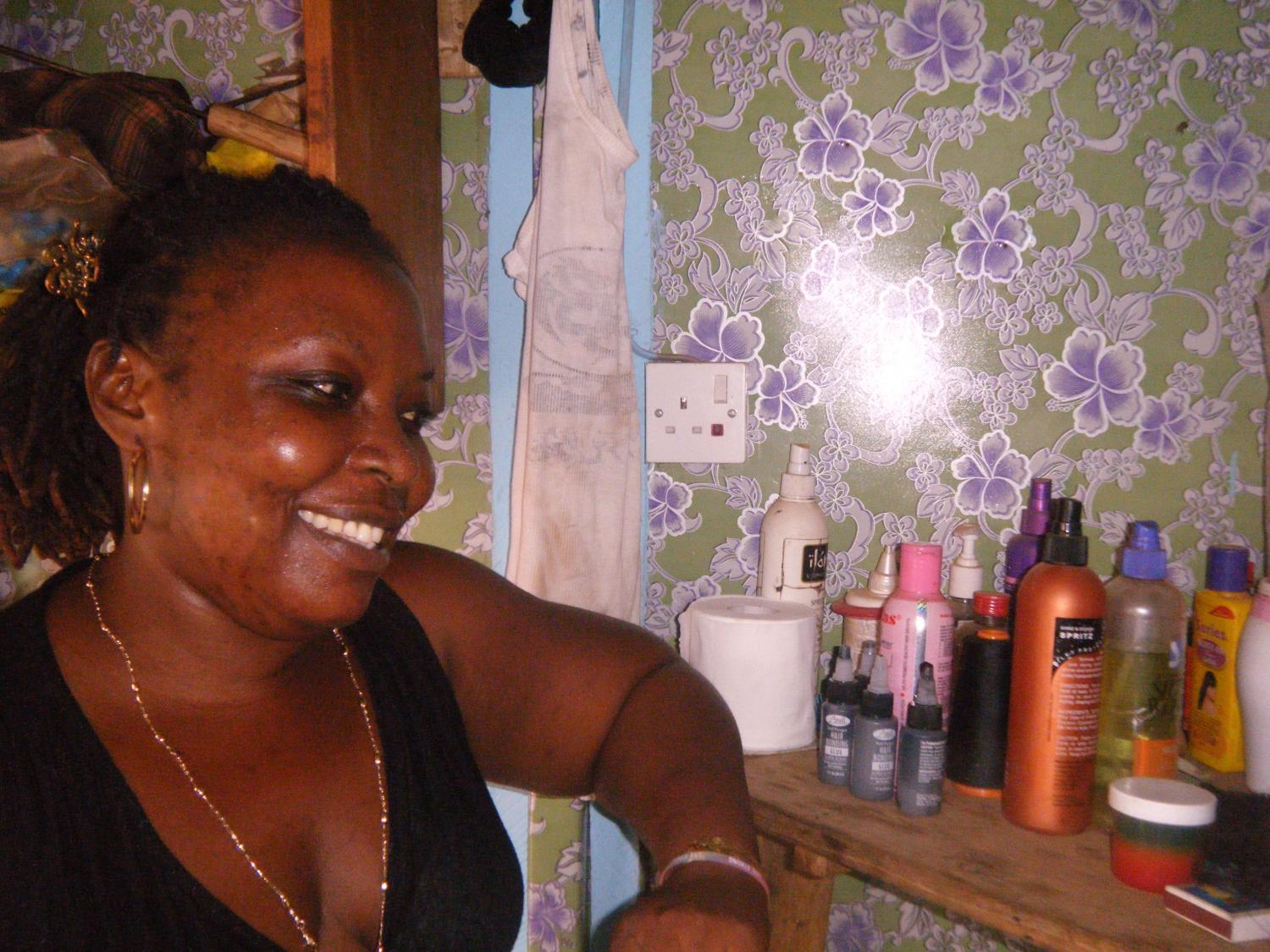 Edith, a Kiva borrower, has a small wooden hair studio in Torkpoi town.