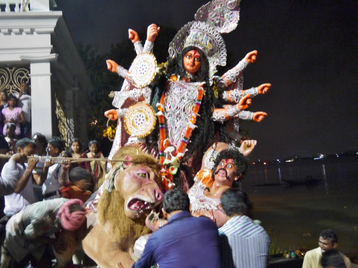 Idols being carried down the ghats into the river