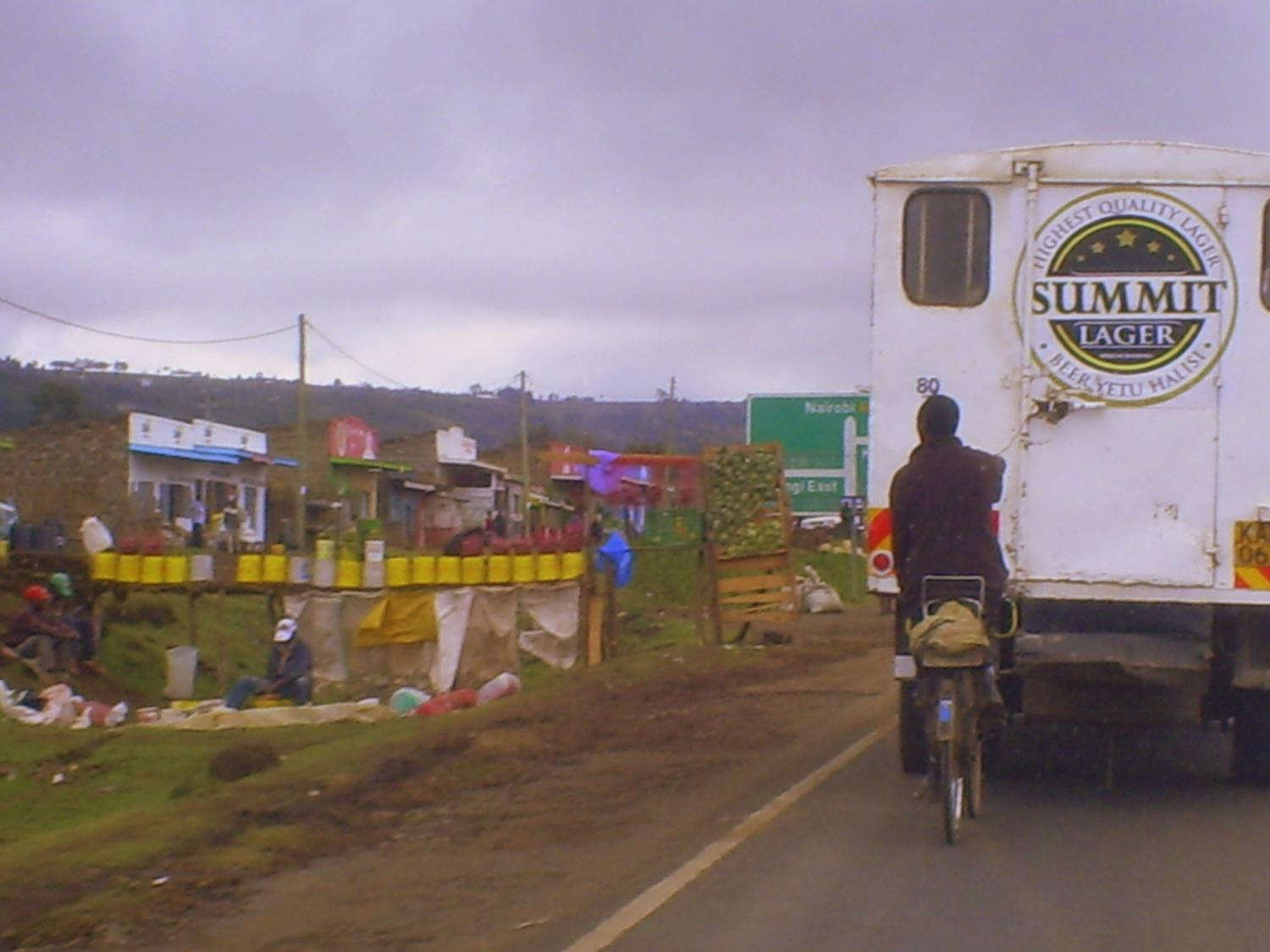 A memorable sight near Naivasha: Commuter looking at road-side produce stand