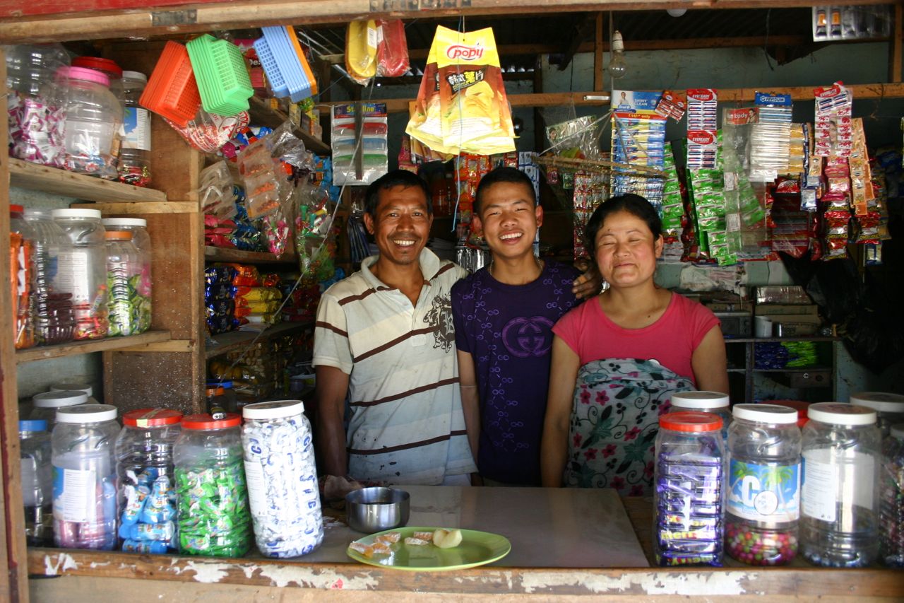 A WSDS-Kiva client with her family in her store