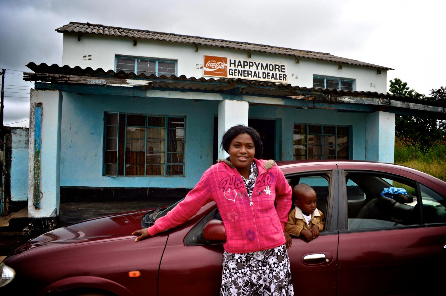 Marvelous in front of her shop and car