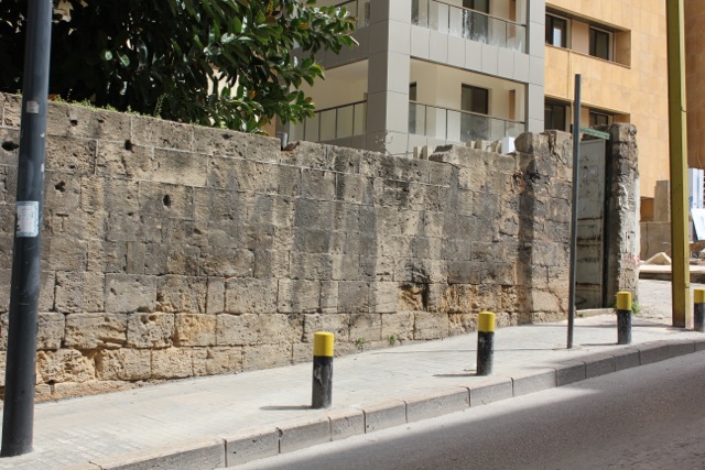 The bullet-ridden wall behind which we find the walk leading to the offices of Al Majmoua in Beirut.